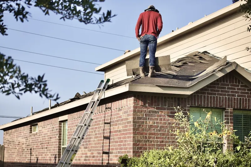 Professional roofer working on a residential roof in Cobblestone